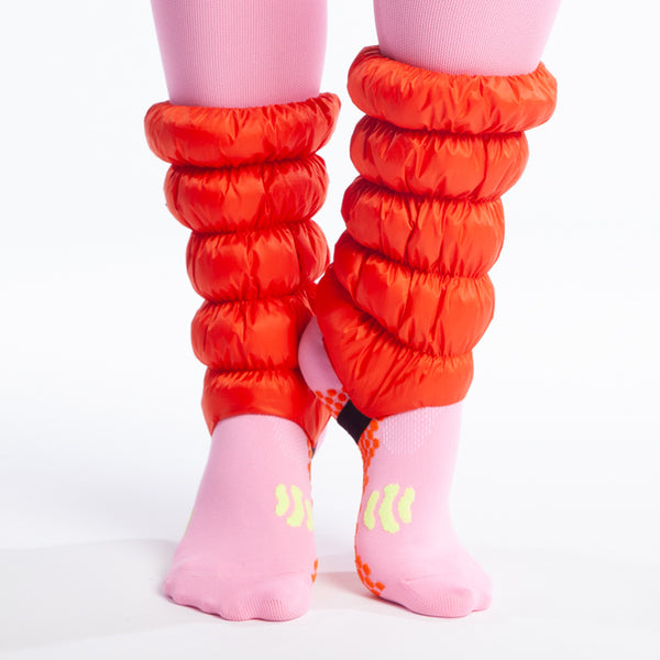 Hikas Gaiter in Very Vermillion feet are on tip toes and left heel is making contact with right ankle. 
